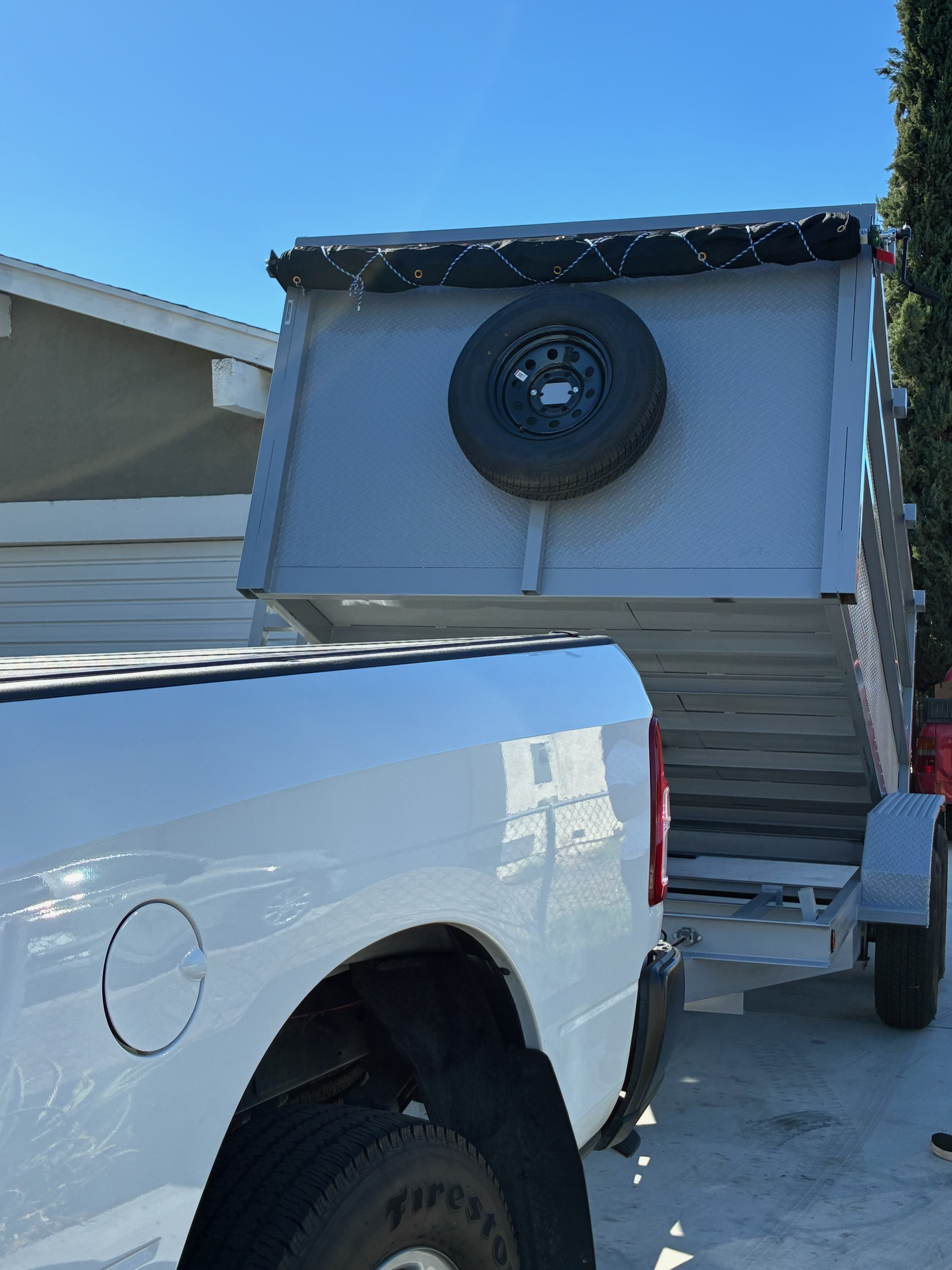 Trailer with bed tilted for dumping