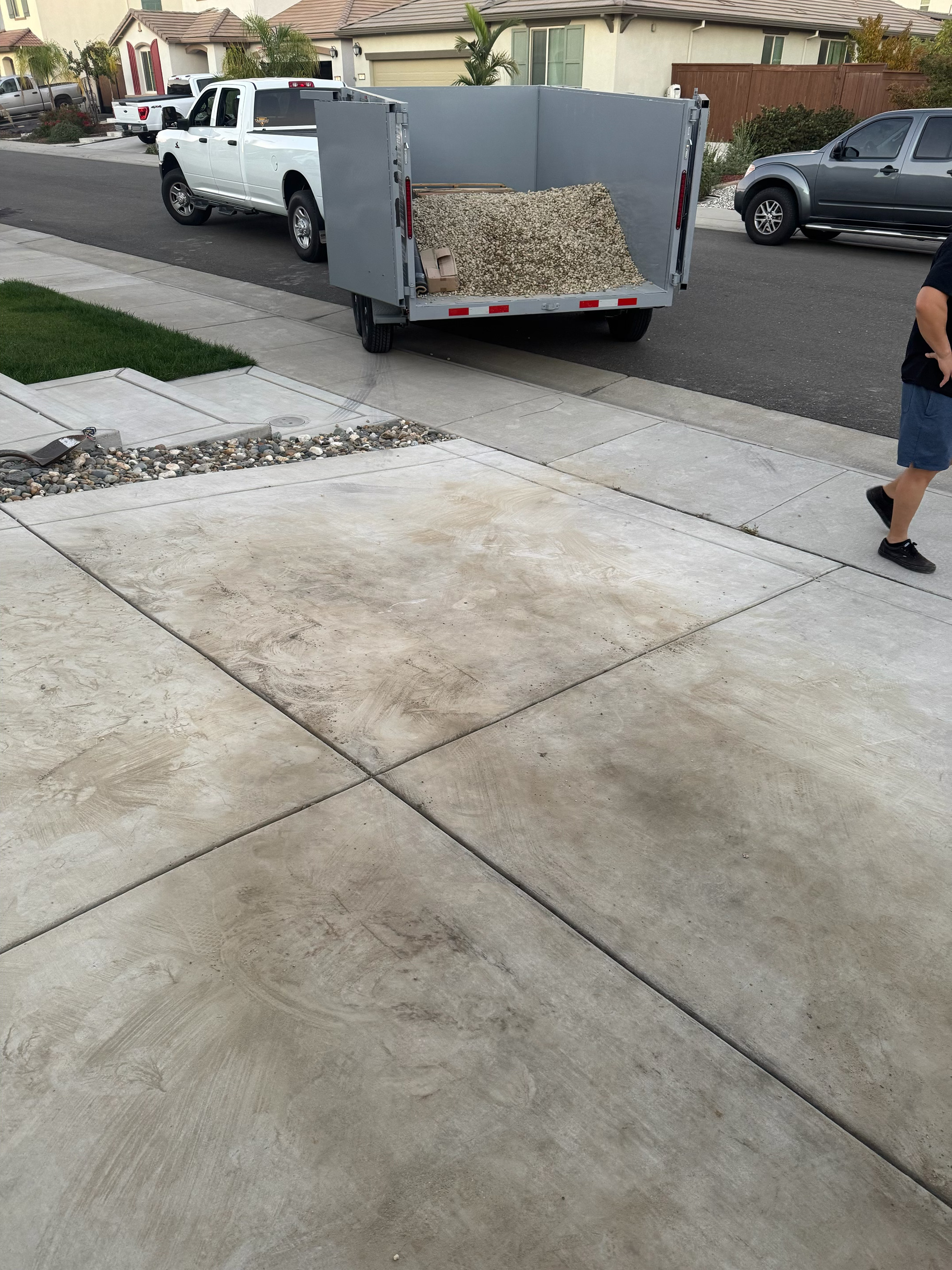 After - Clean driveway with All Dat Junk trailer loaded with gravel